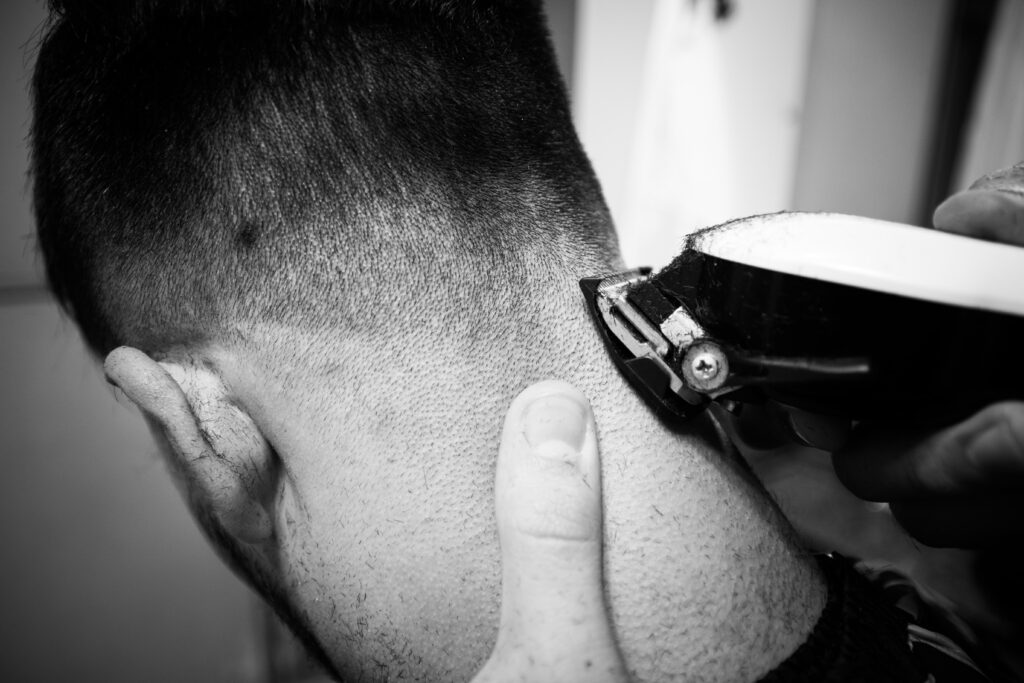 Close-up of a precise neck fade haircut with clippers, offering the best barber experience in Larnaca.