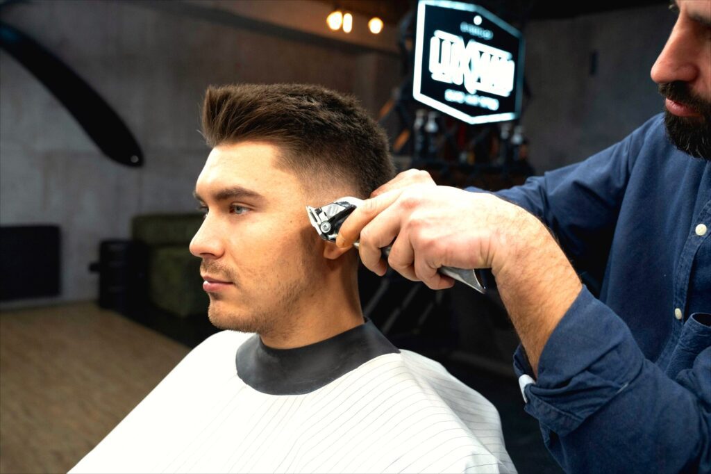 Barber giving a precise clipper fade haircut to a man, showcasing the best barber experience in Larnaca.
